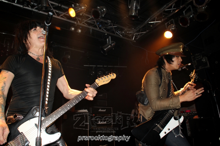 LA Guns vocalist Phil Lewis and guitarist Michael Grant performing together on the Vamp'd stage.